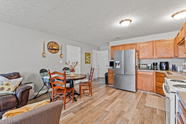 416 Scottsdale Cir, Lexington, KY 40511 - kitchen with stainless steel fridge with ice dispenser, electric range, light wood-style floors, open floor plan, and light countertops