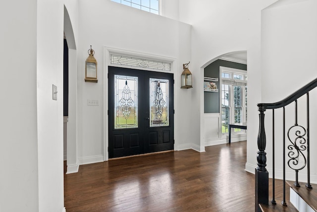 1022 Forest Hill Dr, Lawrenceburg, KY 40342 - foyer featuring arched walkways, french doors, wood finished floors, a high ceiling, and stairs