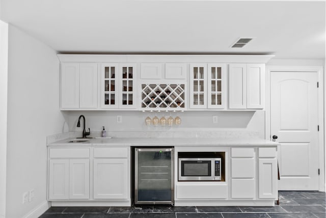 1022 Forest Hill Dr, Lawrenceburg, KY 40342 - indoor wet bar featuring wine cooler and stainless steel microwave