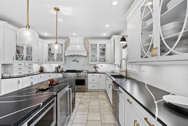 1022 Forest Hill Dr, Lawrenceburg, KY 40342 - kitchen featuring appliances with stainless steel finishes, dark countertops, custom exhaust hood, light marble finish flooring, and tasteful backsplash