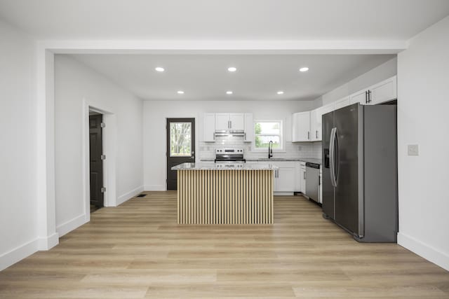 460 Spring St, Mt Sterling, KY 40353 - kitchen with appliances with stainless steel finishes, recessed lighting, white cabinetry, decorative backsplash, and a kitchen island
