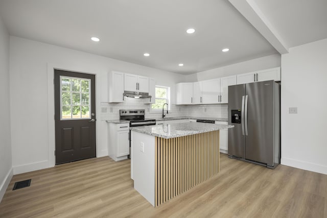 460 Spring St, Mt Sterling, KY 40353 - kitchen featuring stainless steel appliances, light wood-style flooring, under cabinet range hood, a center island, and recessed lighting