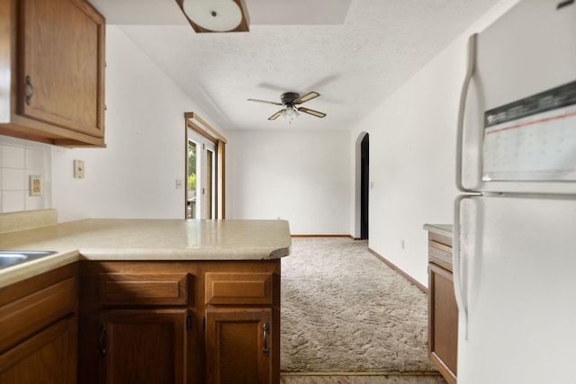 2299 Mcbrayer Rd, Clearfield, KY 40313 - kitchen featuring freestanding refrigerator, carpet, a peninsula, ceiling fan, and light countertops