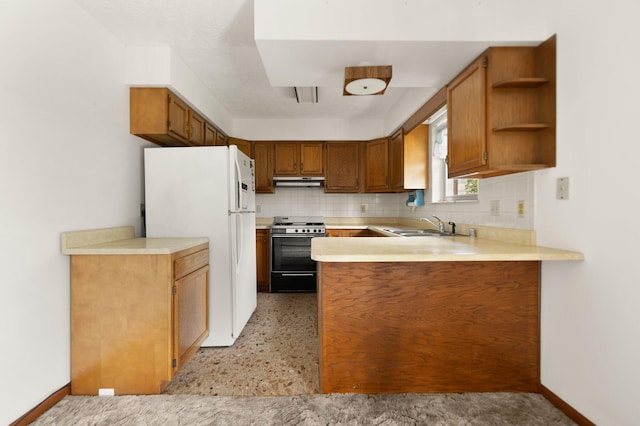 2299 Mcbrayer Rd, Clearfield, KY 40313 - kitchen featuring gas range oven, freestanding refrigerator, under cabinet range hood, a peninsula, and light countertops