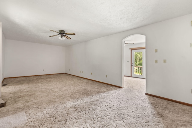 2299 Mcbrayer Rd, Clearfield, KY 40313 - carpeted empty room featuring a ceiling fan, arched walkways, and a textured ceiling