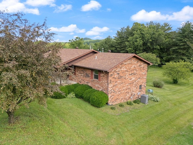2299 Mcbrayer Rd, Clearfield, KY 40313 - view of side of property featuring brick siding, roof with shingles, and a lawn