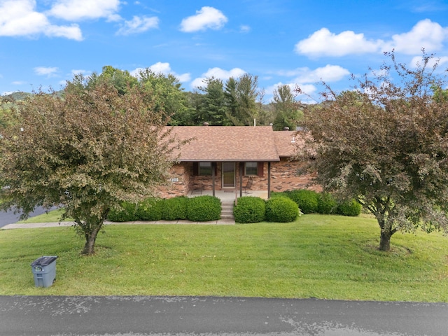 2299 Mcbrayer Rd, Clearfield, KY 40313 - view of front of home with a porch, a front yard, brick siding, and roof with shingles