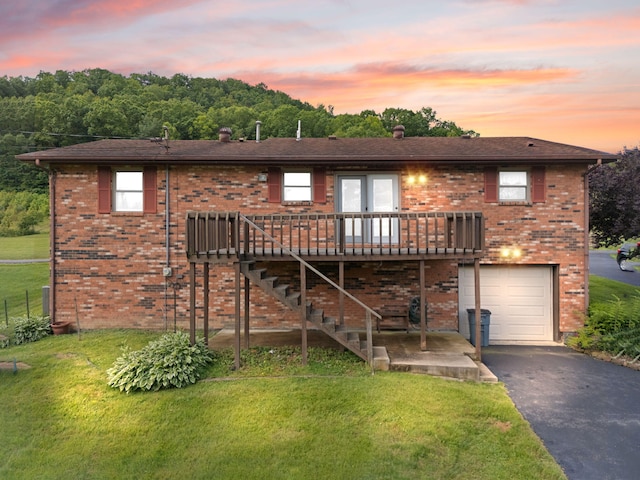 2299 Mcbrayer Rd, Clearfield, KY 40313 - view of front of home featuring asphalt driveway, a front yard, a garage, and a wooden deck