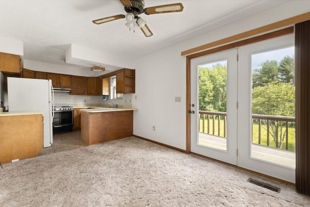 2299 Mcbrayer Rd, Clearfield, KY 40313 - kitchen featuring stainless steel electric range oven, light countertops, healthy amount of natural light, and a peninsula