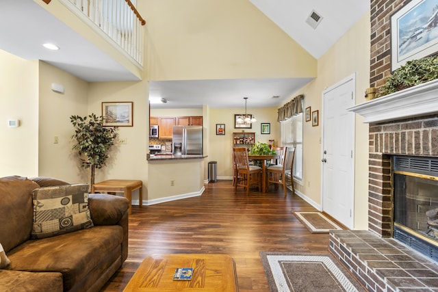102 Dickinson Ct, Georgetown, KY 40324 - living room featuring a brick fireplace, dark wood finished floors, high vaulted ceiling, and a chandelier