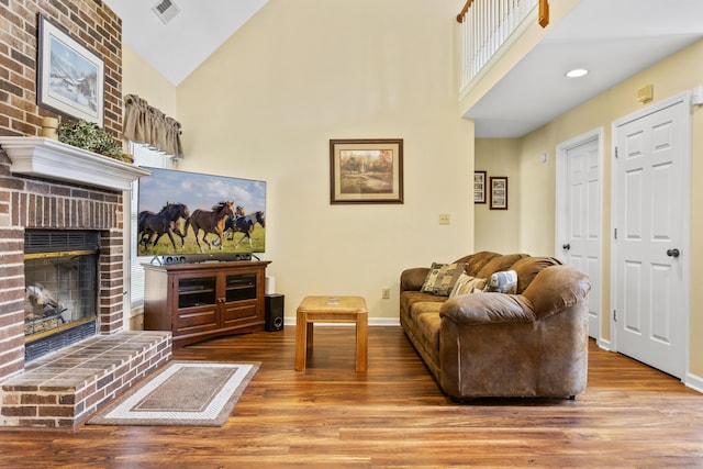 102 Dickinson Ct, Georgetown, KY 40324 - living room featuring wood finished floors, high vaulted ceiling, and a brick fireplace