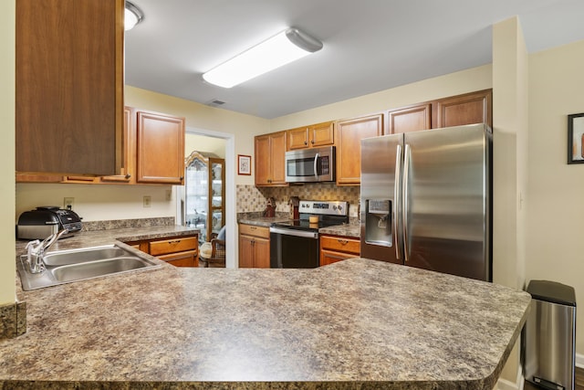 102 Dickinson Ct, Georgetown, KY 40324 - kitchen with appliances with stainless steel finishes, a peninsula, and brown cabinetry