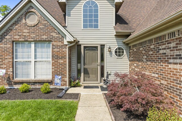 102 Dickinson Ct, Georgetown, KY 40324 - doorway to property featuring a shingled roof and brick siding