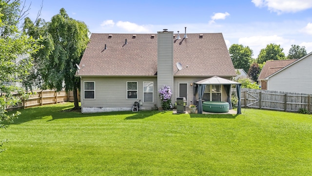 102 Dickinson Ct, Georgetown, KY 40324 - rear view of house featuring a hot tub, a gazebo, a fenced backyard, a chimney, and roof with shingles