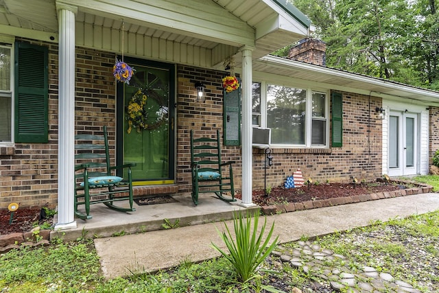 1390 Ky Highway 698, Stanford, KY 40484 - view of exterior entry with a porch, brick siding, and a chimney