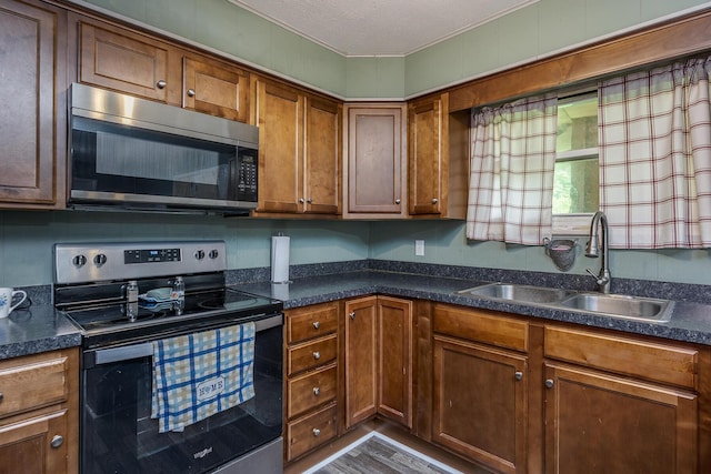 1390 Ky Highway 698, Stanford, KY 40484 - kitchen with stainless steel appliances, dark countertops, and brown cabinetry