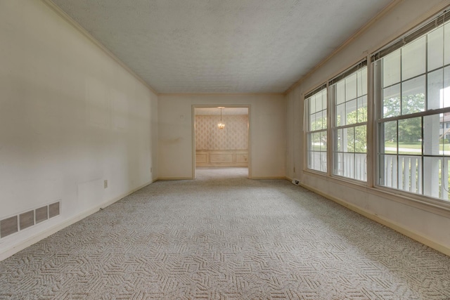 230 Fairway Dr, Nicholasville, KY 40356 - carpeted empty room with crown molding, healthy amount of natural light, a textured ceiling, and a chandelier