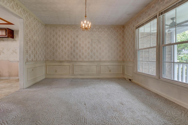 230 Fairway Dr, Nicholasville, KY 40356 - unfurnished room with a chandelier, ornamental molding, light colored carpet, wallpapered walls, and wainscoting