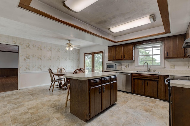 230 Fairway Dr, Nicholasville, KY 40356 - kitchen with dishwasher, a tray ceiling, light countertops, white microwave, and a ceiling fan