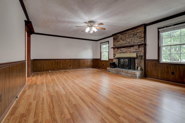 230 Fairway Dr, Nicholasville, KY 40356 - unfurnished living room featuring a wainscoted wall, wood finished floors, a textured ceiling, wooden walls, and ceiling fan