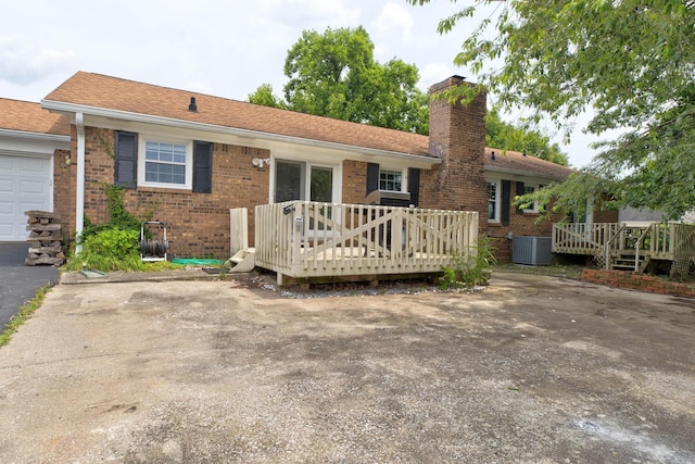 230 Fairway Dr, Nicholasville, KY 40356 - back of property with a deck, brick siding, and a chimney