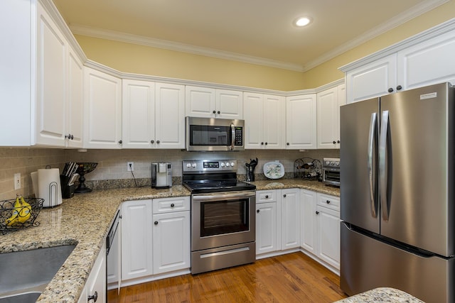 768 Emmett Creek Ln, Lexington, KY 40515 - kitchen with appliances with stainless steel finishes, ornamental molding, white cabinetry, tasteful backsplash, and recessed lighting