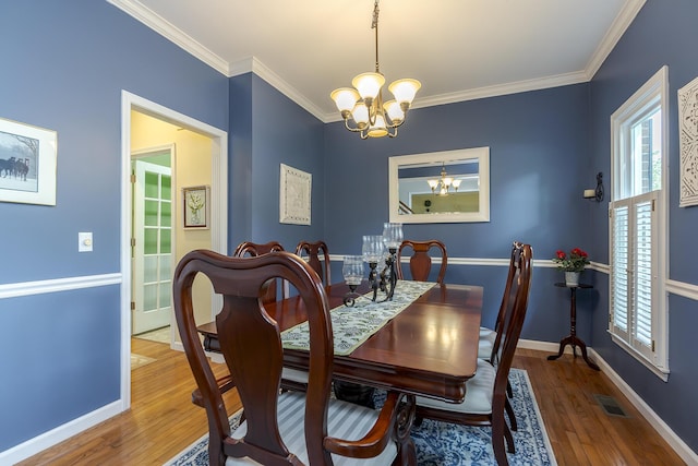 768 Emmett Creek Ln, Lexington, KY 40515 - dining area featuring a chandelier, wood finished floors, plenty of natural light, and crown molding