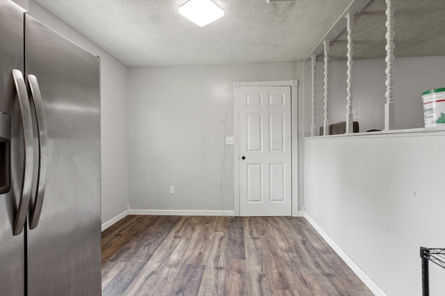 15 Conlee Ln, Stanton, KY 40380 - unfurnished dining area featuring wood finished floors, a textured ceiling, and baseboards