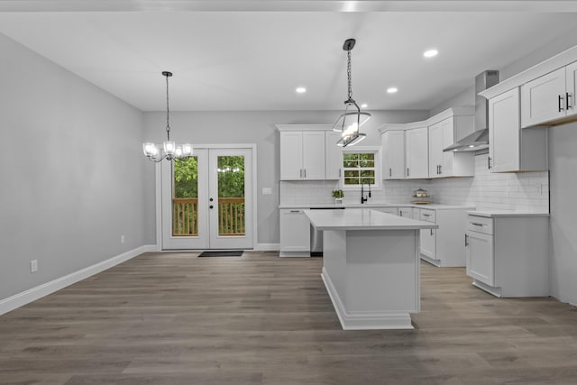 437 Boones Creek Rd, Lancaster, KY 40444 - kitchen featuring wall chimney range hood, tasteful backsplash, white cabinetry, a center island, and recessed lighting