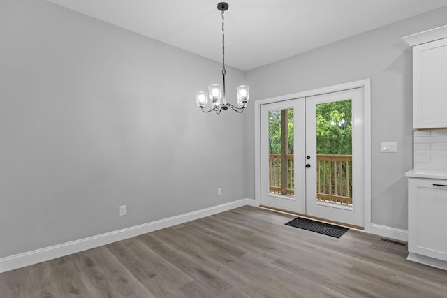 437 Boones Creek Rd, Lancaster, KY 40444 - unfurnished dining area featuring light wood-style flooring, baseboards, a chandelier, and french doors
