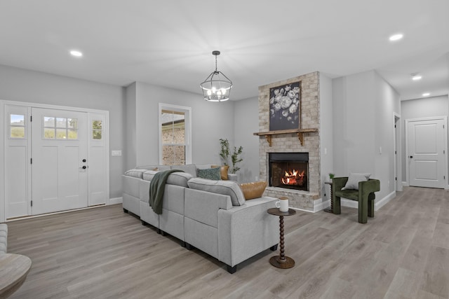 437 Boones Creek Rd, Lancaster, KY 40444 - living area featuring light wood finished floors, baseboards, a brick fireplace, recessed lighting, and a chandelier