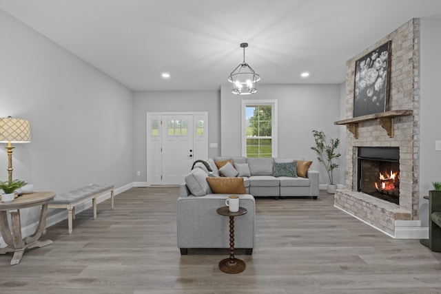 437 Boones Creek Rd, Lancaster, KY 40444 - living area featuring baseboards, a brick fireplace, light wood-type flooring, recessed lighting, and a chandelier