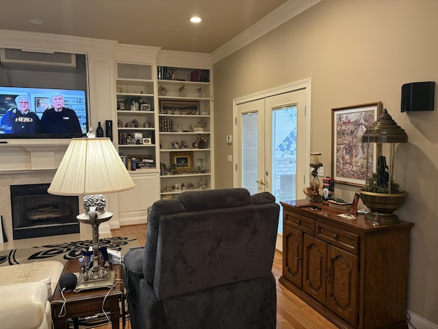 260 Beech Fork Blvd, Clay City, KY 40312 - living room with light wood-style flooring, ornamental molding, french doors, and a fireplace with flush hearth