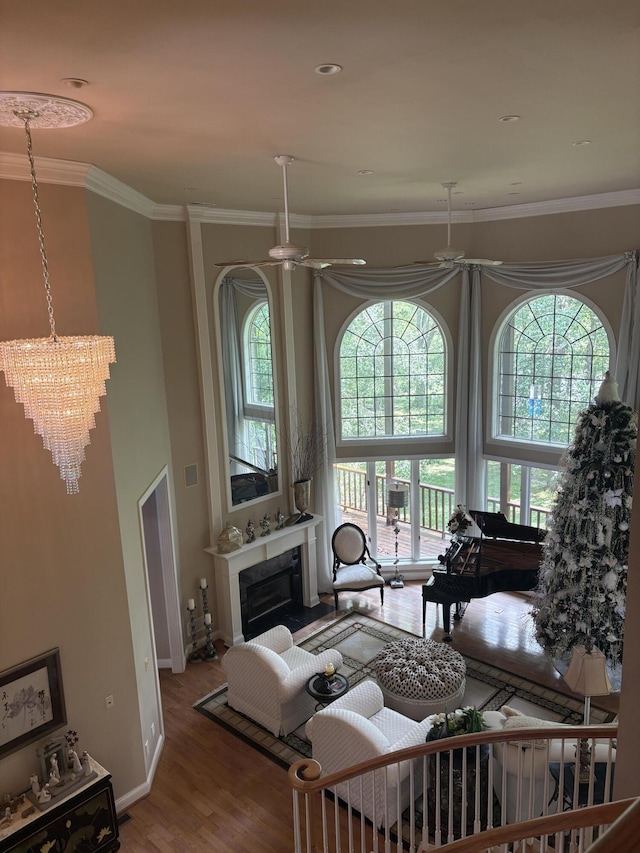 260 Beech Fork Blvd, Clay City, KY 40312 - living room with wood finished floors, plenty of natural light, crown molding, a chandelier, and a glass covered fireplace