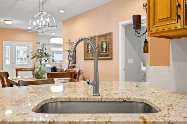 111 Acorn Path, Georgetown, KY 40324 - kitchen featuring light stone counters, brown cabinets, tasteful backsplash, pendant lighting, and recessed lighting