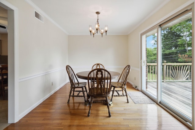 3852 Heimbaugh Ln, Lexington, KY 40514 - dining room featuring crown molding, a chandelier, and light wood-style floors
