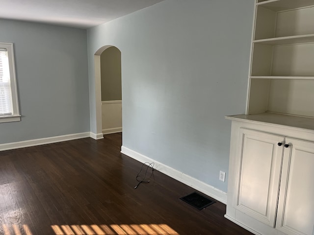 1134 Liberty Rd, Lexington, KY 40505 - empty room with arched walkways and dark wood-style floors
