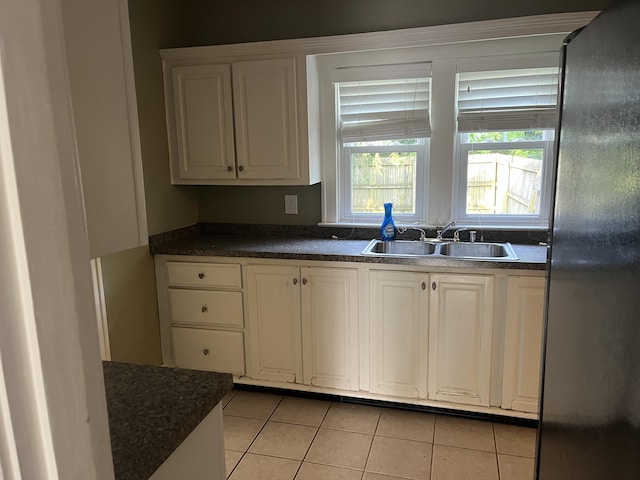 1134 Liberty Rd, Lexington, KY 40505 - kitchen featuring freestanding refrigerator, light tile patterned flooring, and dark countertops