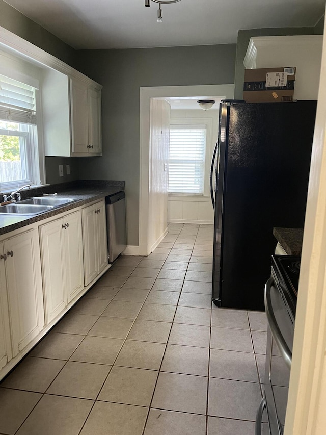 1134 Liberty Rd, Lexington, KY 40505 - kitchen with appliances with stainless steel finishes, light tile patterned floors, dark countertops, and plenty of natural light
