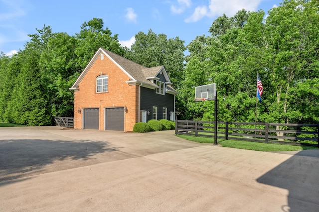 315 Whispering Brook Dr, Nicholasville, KY 40356 - view of side of home featuring an attached garage, concrete driveway, brick siding, and a shingled roof