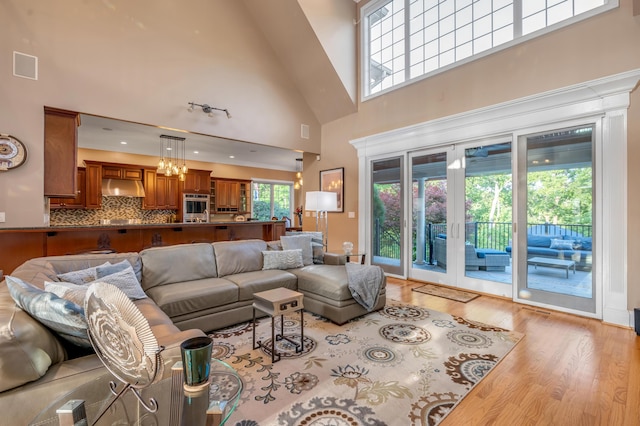 315 Whispering Brook Dr, Nicholasville, KY 40356 - living area featuring a towering ceiling, wood finished floors, french doors, and a chandelier