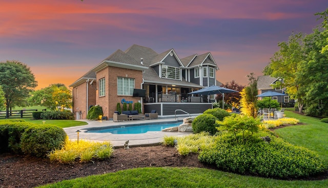 315 Whispering Brook Dr, Nicholasville, KY 40356 - back of property featuring outdoor lounge area, brick siding, an outdoor pool, and a patio area