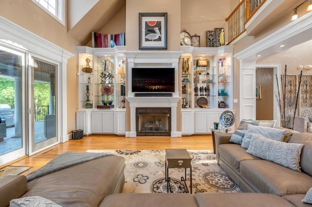 315 Whispering Brook Dr, Nicholasville, KY 40356 - living room featuring a towering ceiling, wood finished floors, and a fireplace