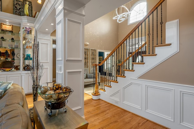 315 Whispering Brook Dr, Nicholasville, KY 40356 - entrance foyer with light wood finished floors, stairs, a decorative wall, a chandelier, and a wainscoted wall
