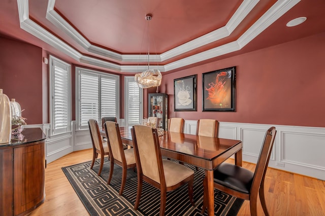 315 Whispering Brook Dr, Nicholasville, KY 40356 - dining area featuring a tray ceiling, crown molding, a chandelier, a decorative wall, and light wood-type flooring