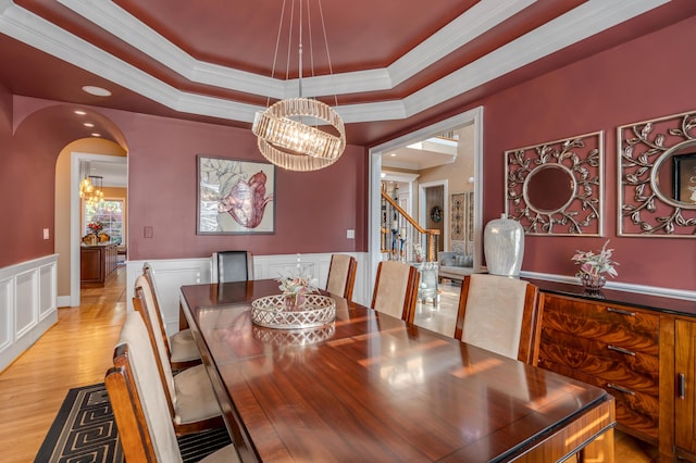 315 Whispering Brook Dr, Nicholasville, KY 40356 - dining room with a chandelier, a raised ceiling, light wood-style floors, crown molding, and a wainscoted wall