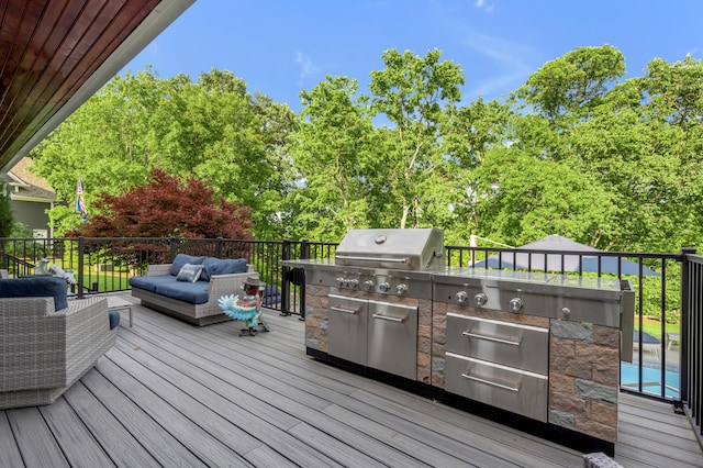 315 Whispering Brook Dr, Nicholasville, KY 40356 - deck with exterior kitchen, an outdoor living space, and view of wooded area