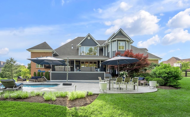 315 Whispering Brook Dr, Nicholasville, KY 40356 - rear view of property featuring a patio area, a yard, an outdoor pool, and a shingled roof