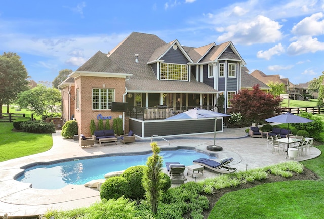 315 Whispering Brook Dr, Nicholasville, KY 40356 - rear view of house with outdoor lounge area, a patio area, an outdoor pool, and a shingled roof