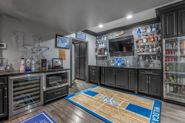 315 Whispering Brook Dr, Nicholasville, KY 40356 - indoor wet bar with beverage cooler, stainless steel microwave, decorative backsplash, light wood-style flooring, and recessed lighting